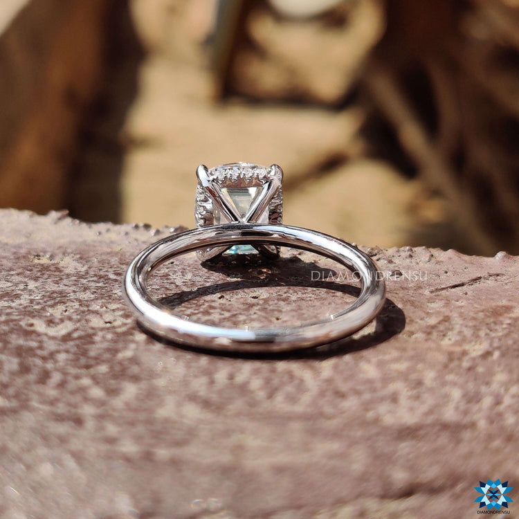 Solitaire engagement ring featuring old mine cut moissanite.
