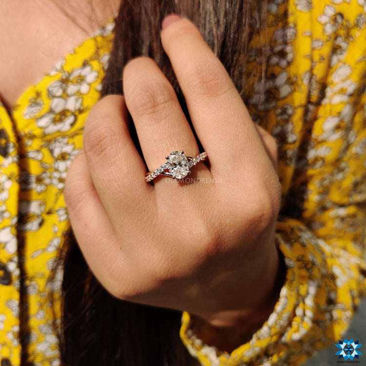 Rose gold engagement ring with twisted band design.

