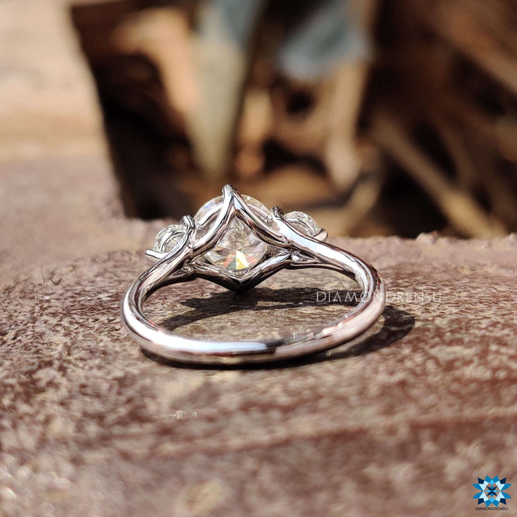 Handmade white gold ring with three round cut moissanites.

