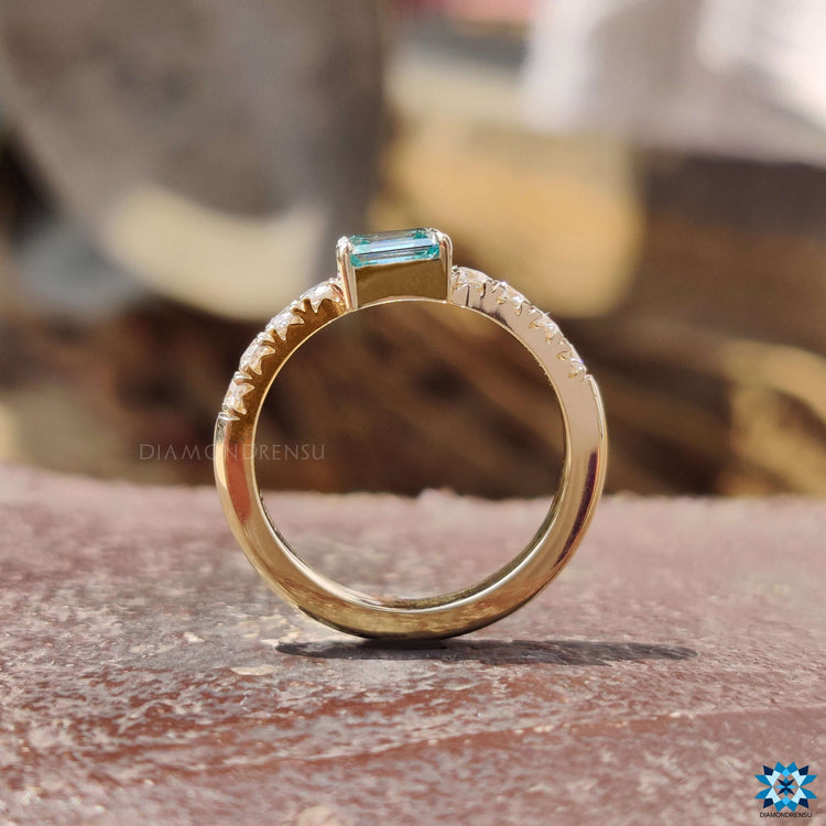 Custom engagement ring with emerald cut moissanite.
