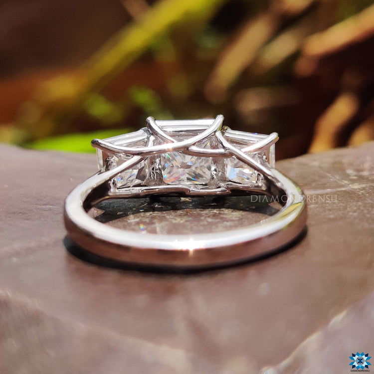 Prong set princess cut ring with side stones.
