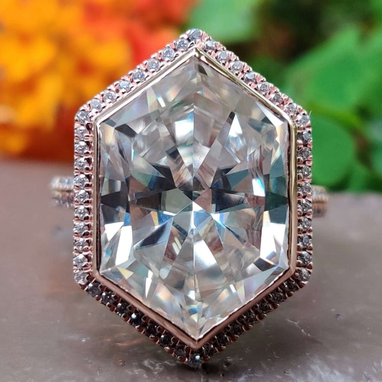 Elongated hexagon moissanite engagement ring in rose gold.
