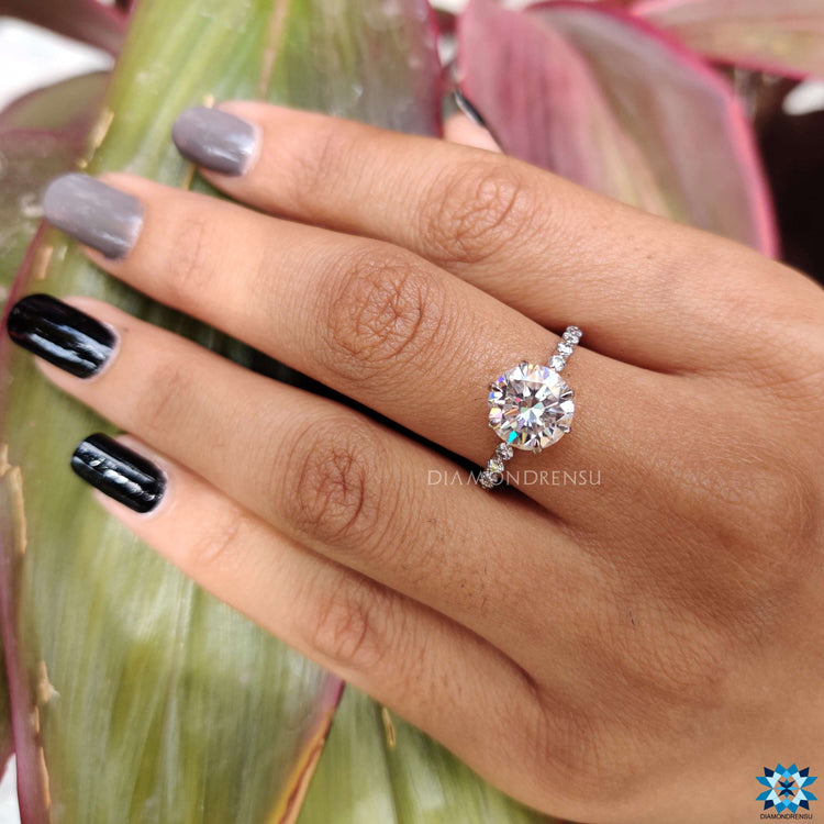 Custom engagement ring with round moissanite and pave accents.
