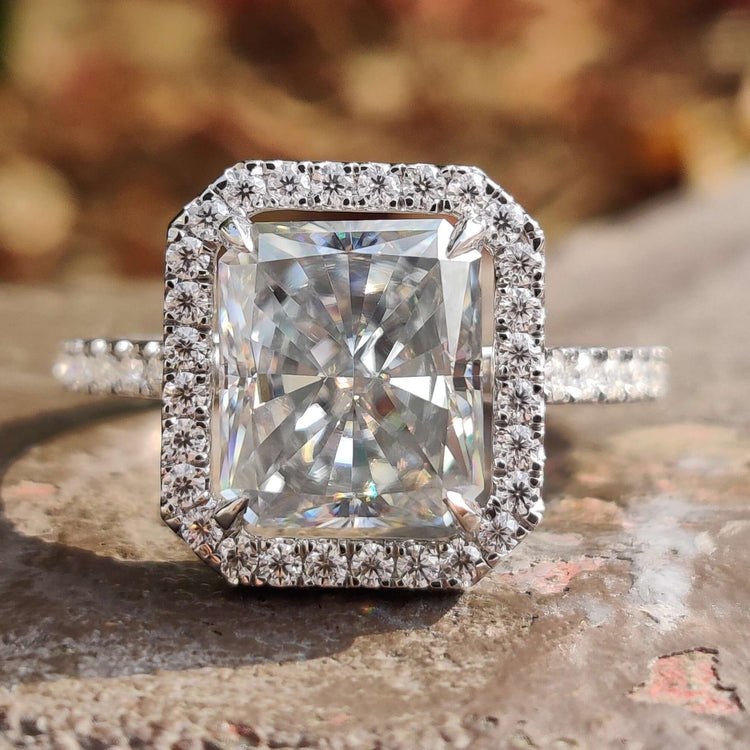 Radiant cut engagement ring featuring a halo design in white gold.
