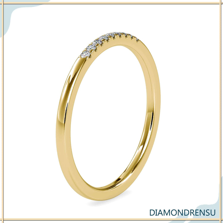Gold wedding band with round cut lab diamonds.

