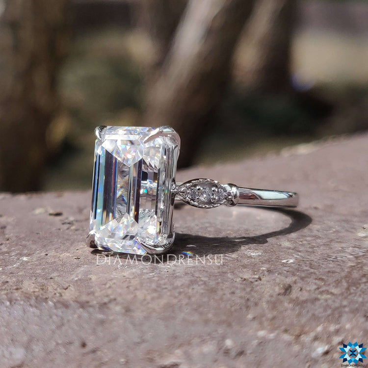Handmade emerald cut engagement ring with claw prongs.
