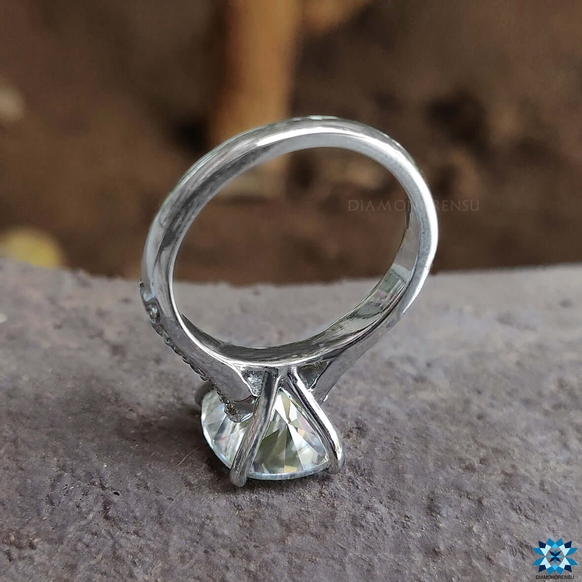 Shared prong ring with a cushion cut engagement ring for secure brilliance.