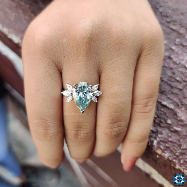 Blue moissanite ring with marquise side stones.
