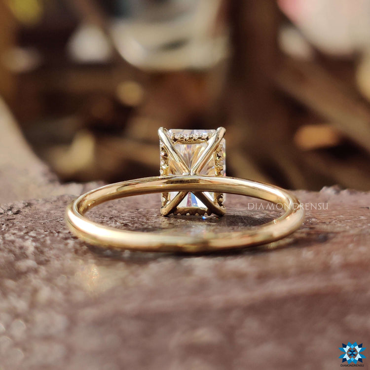 Hidden halo solitaire engagement ring with radiant cut center stone.
