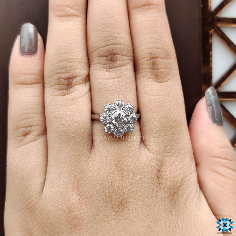 Handmade bezel engagement ring with halo and detailed milgrain edges.
