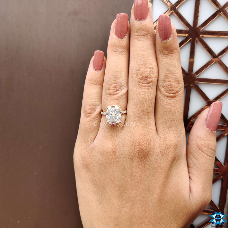 Custom yellow gold engagement ring with radiant moissanite.
