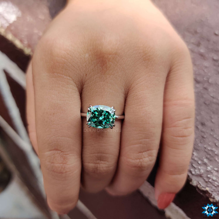 East west moissanite solitaire with double claw prongs.
