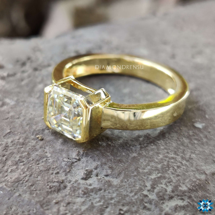 Handmade yellow gold ring featuring Asscher cut stone.
