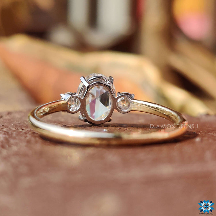 Yellow and white gold engagement ring with oval rose cut centerpiece.
