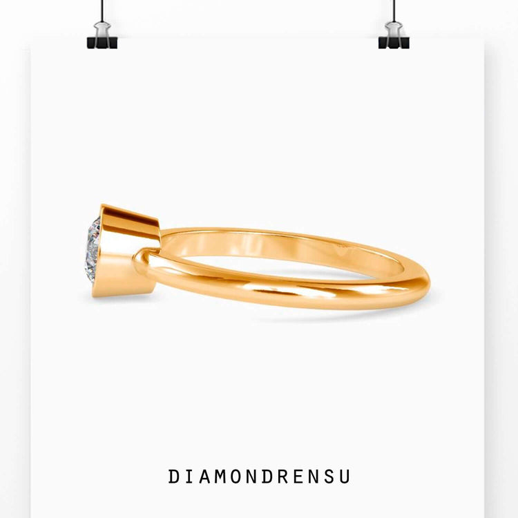 Designer engagement ring with bezel setting and white gold finish.
