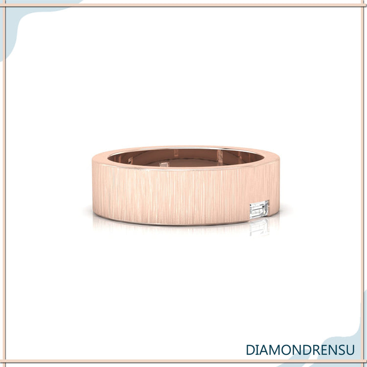 Single baguette diamond in mens wedding band with brushed finish.
