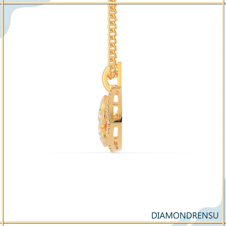 Elegant round diamond pendant in yellow gold heart setting.
