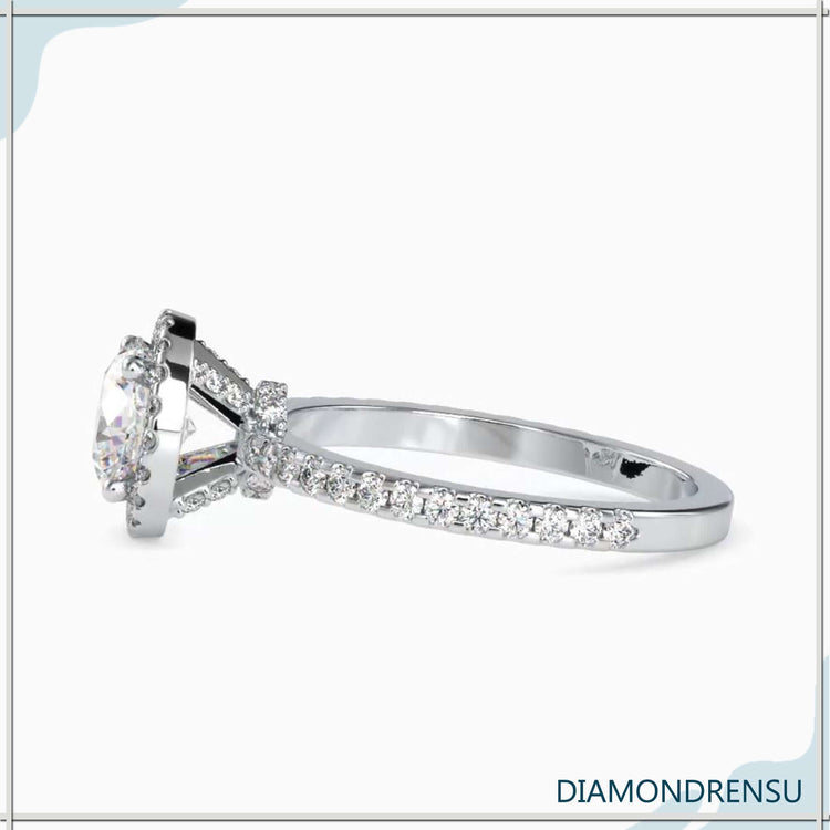 Yellow gold ring featuring hidden halo and round cut diamond.
