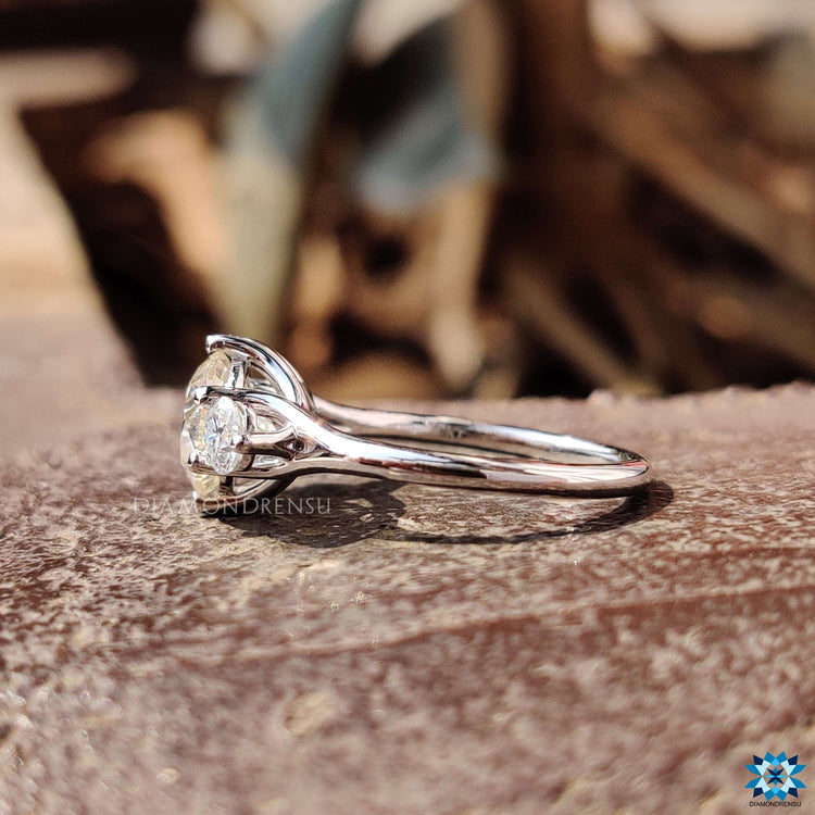 Three stone moissanite ring crafted in polished white gold.
