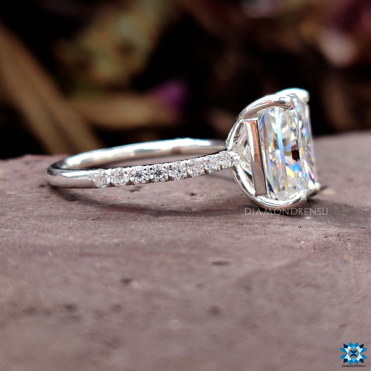 Radiant cut moissanite ring with pave setting.
