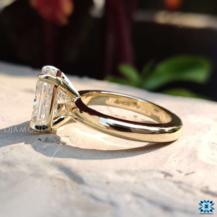 Custom yellow gold engagement ring with radiant moissanite center.
