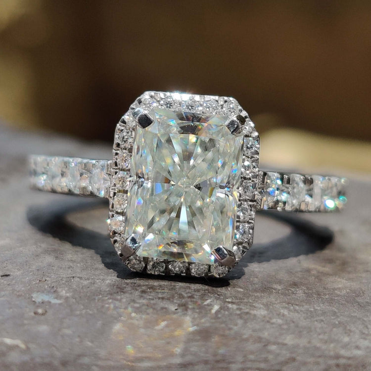 Radiant cut engagement ring with halo and hidden halo design.

