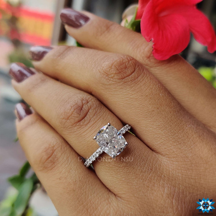 White gold ring with elongated cushion moissanite center.
