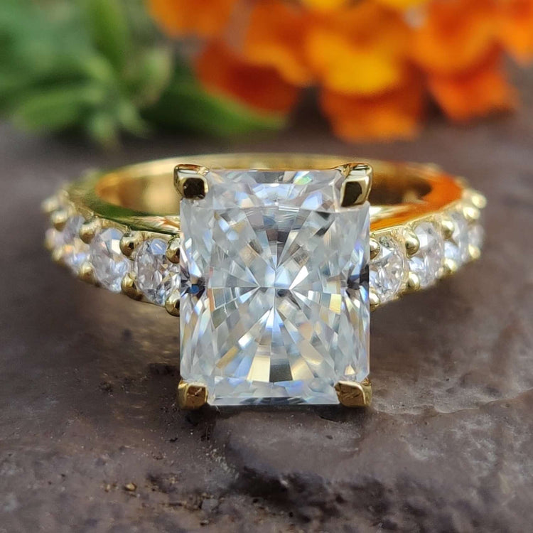 Radiant cut moissanite engagement ring in yellow gold.
