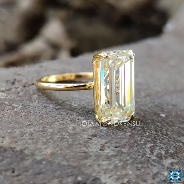 Handmade ring crafted in yellow gold with elegant emerald cut moissanite.
