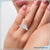 2 carat round cut diamond ring featuring an elegant three stone design.
