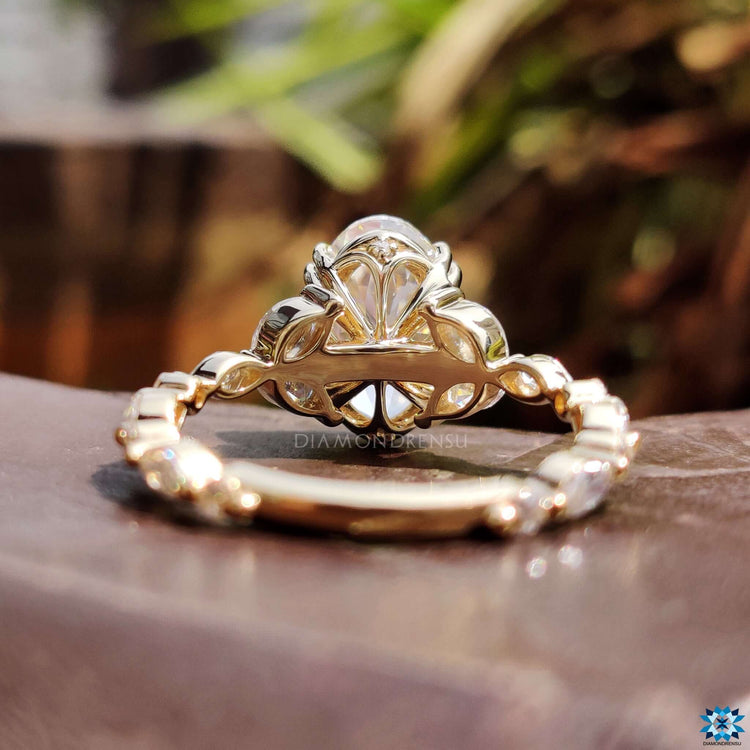 Handmade moissanite ring featuring oval Rensu cut center and shared prong details.
