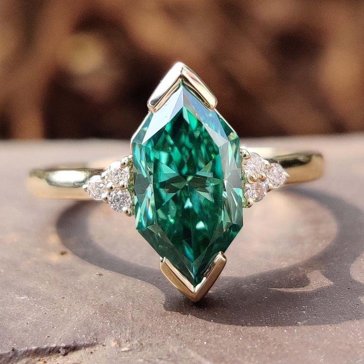 Green Dutch marquise cut moissanite ring with an infinity shank design.
