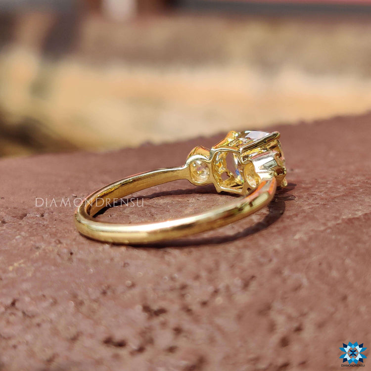 Cushion old mine cut engagement ring paired with light yellow old European accents.
