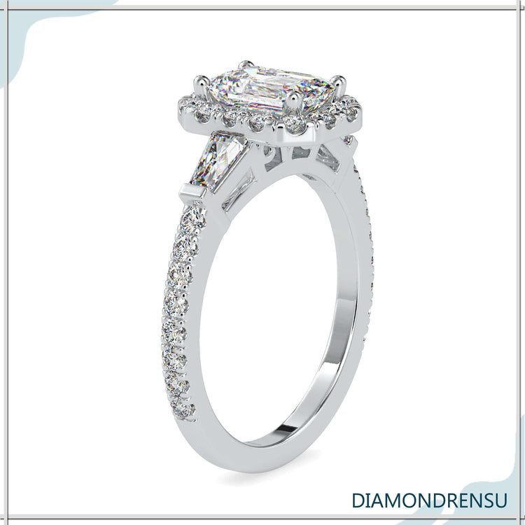 Custom engagement ring featuring emerald and round cuts.
