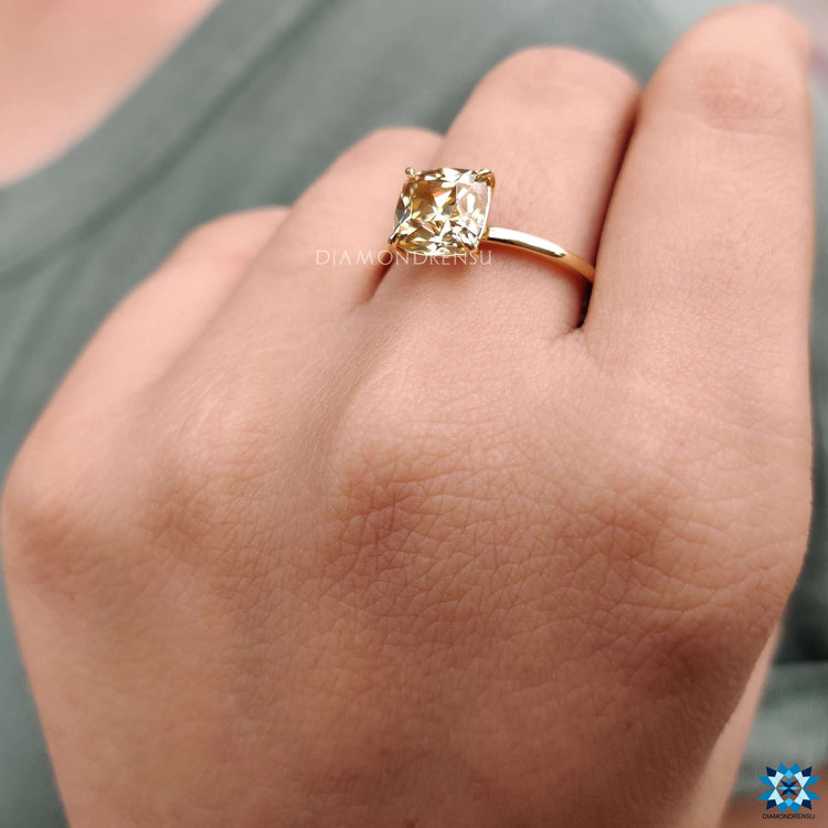 Cushion cut moissanite ring with vintage-inspired design.
