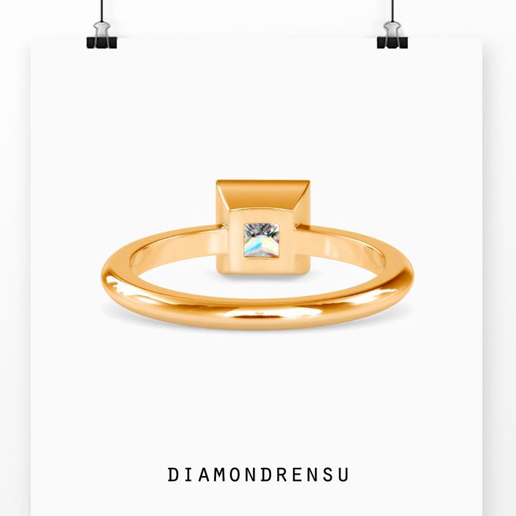 Custom design ring with princess cut diamond and bezel solitaire mount.
