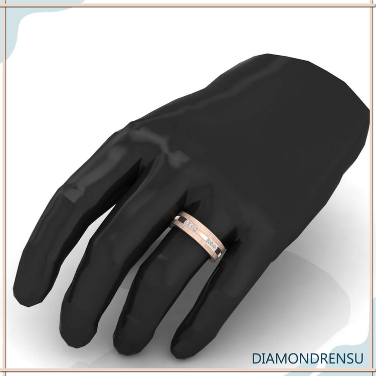 Satin finish band with carved channel band in yellow gold.
