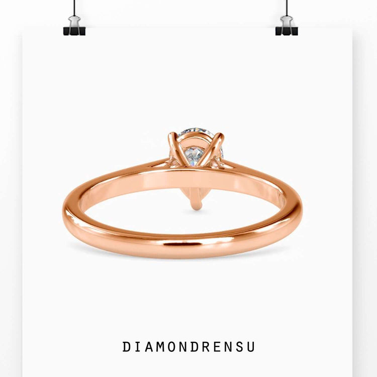 Custom engagement ring with teardrop diamond design.
