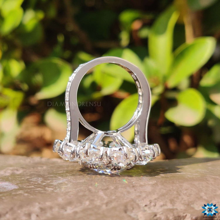 Cluster halo ring featuring oval rose cut moissanite centre.
