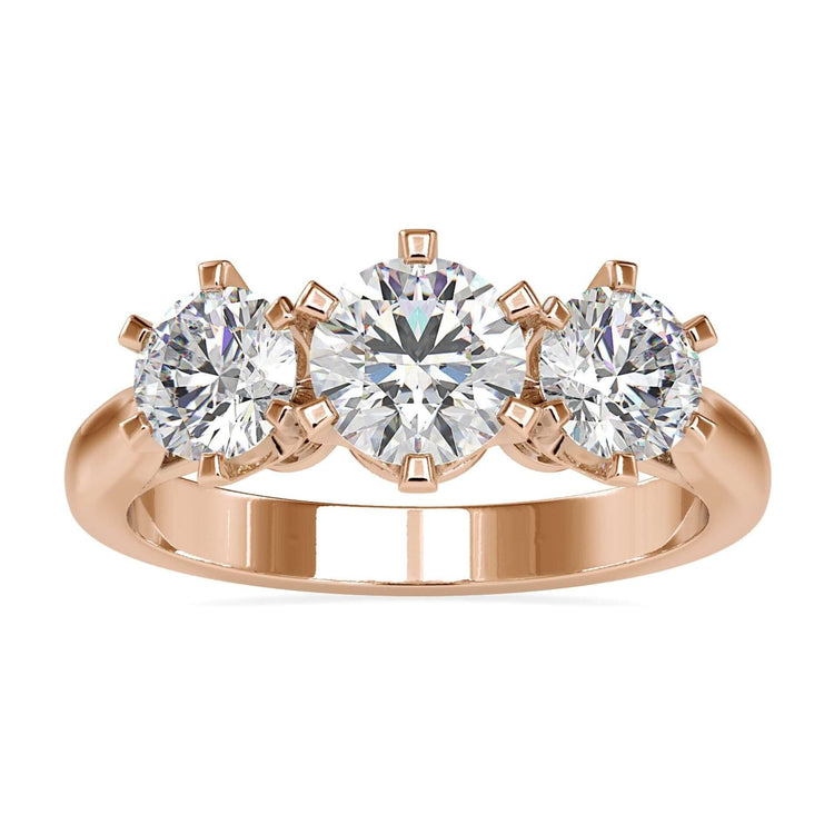 Three stone gold ring with round cut diamonds in tab prong setting.
