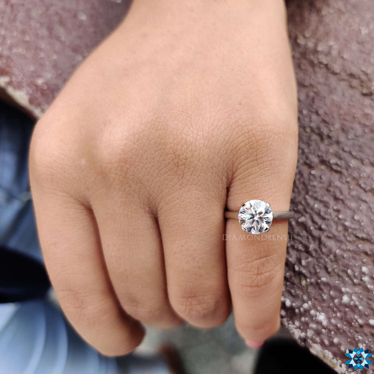 Round moissanite ring in cathedral setting.

