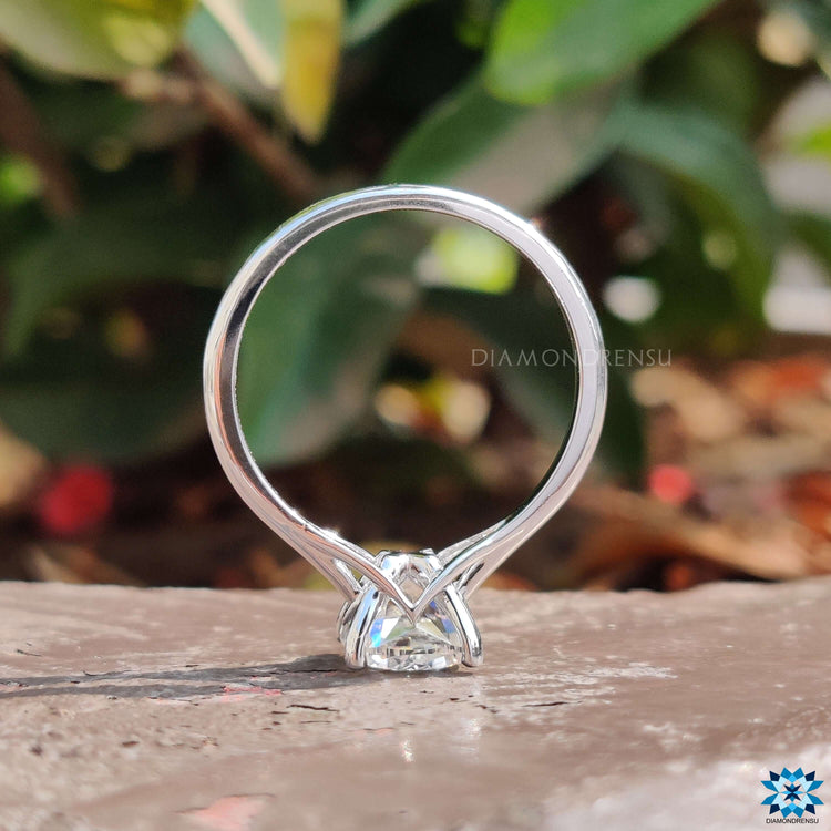 Custom solitaire ring with cushion moissanite and classic four prong setting.
