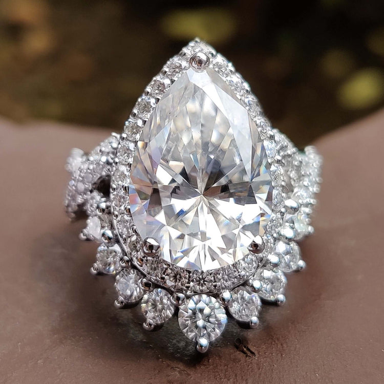 Pear shaped engagement ring with crushed ice moissanite.
