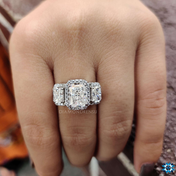 Art deco style moissanite ring with radiant and round stones.

