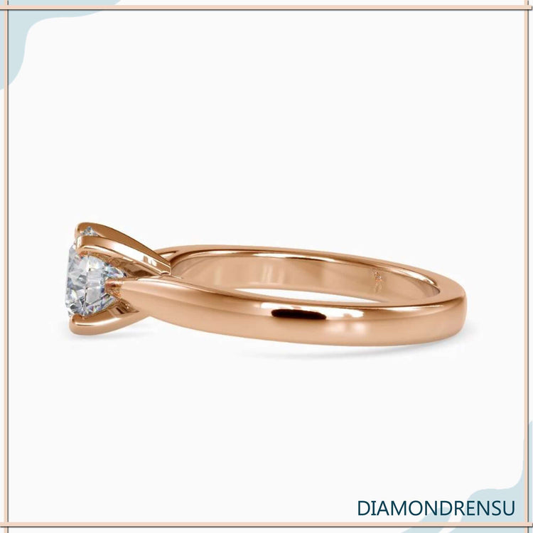 Custom design ring with tab prong round diamond setting.
