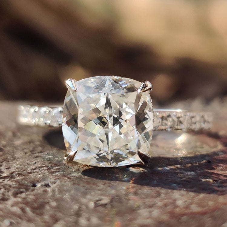 Hidden halo engagement ring with cushion divine cut stone.
