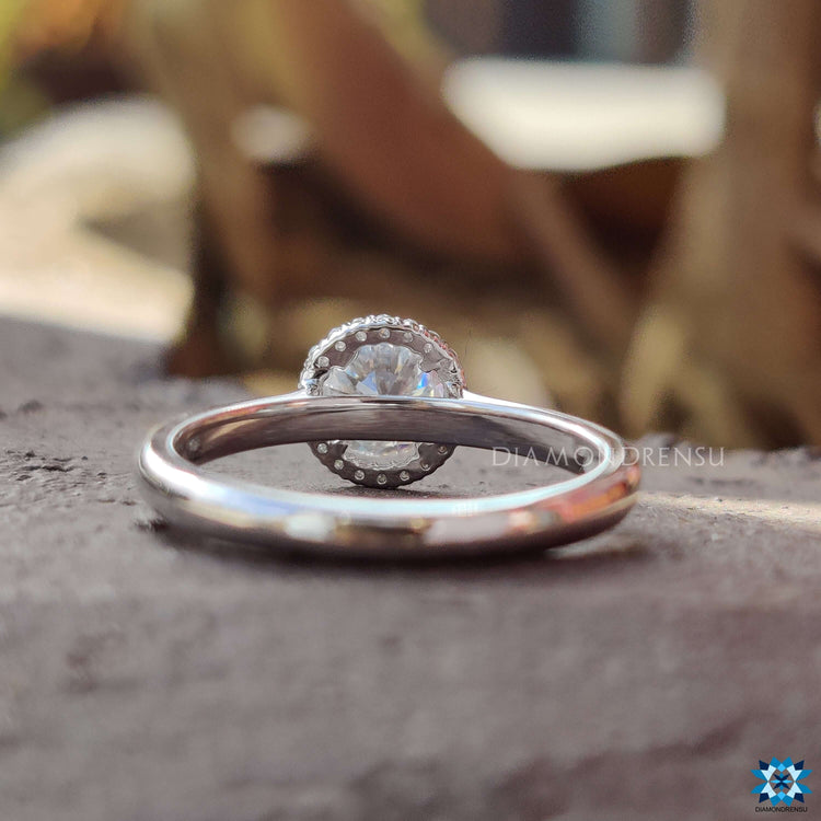 Handmade halo ring with round moissanite center.
