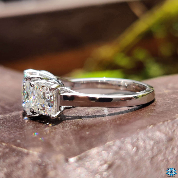 Elegant white gold ring with three stone design.
