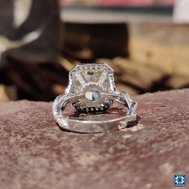 Halo engagement ring featuring radiant cut center stone.

