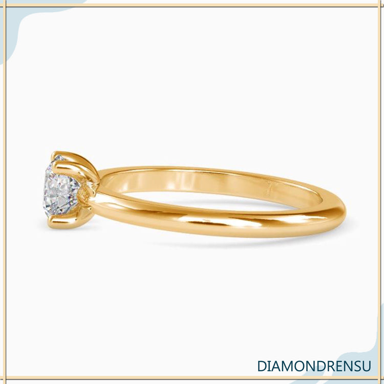 Designer ring featuring white gold band and round diamond solitaire.
